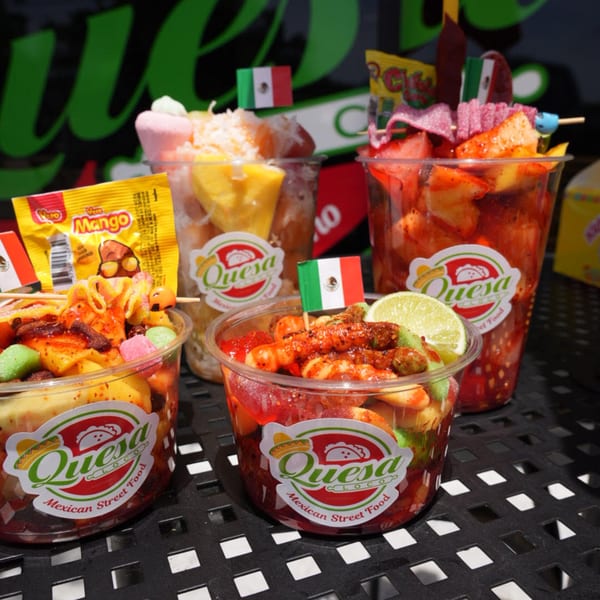 Four cups of Mexican street food, including fruit, candy, and chili, with Quesa Loco branding.